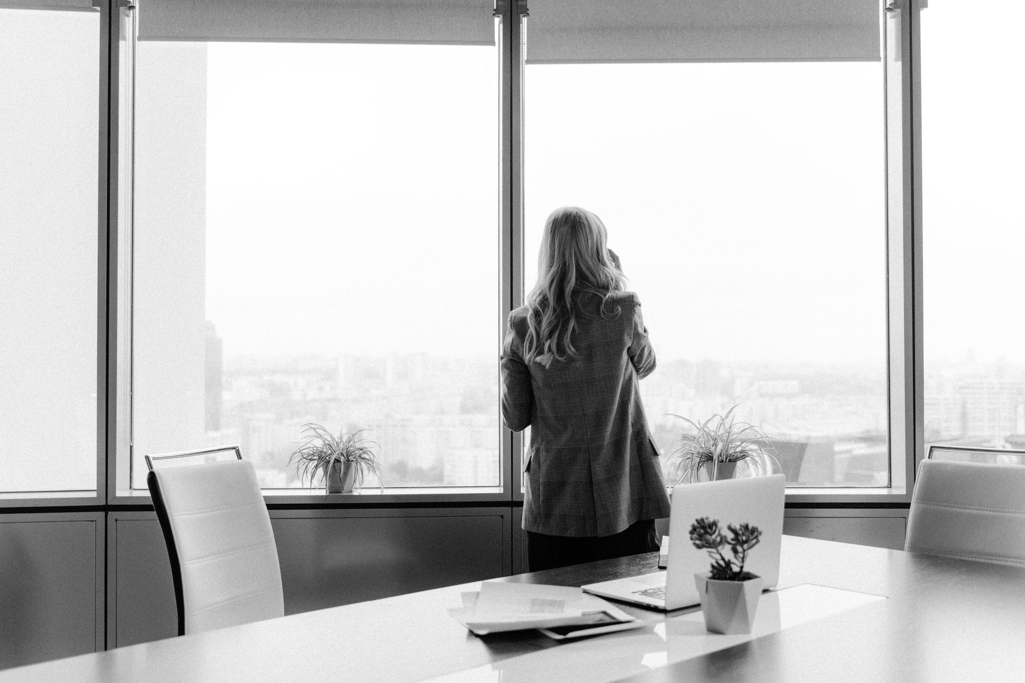 A business leader looking out of an office window